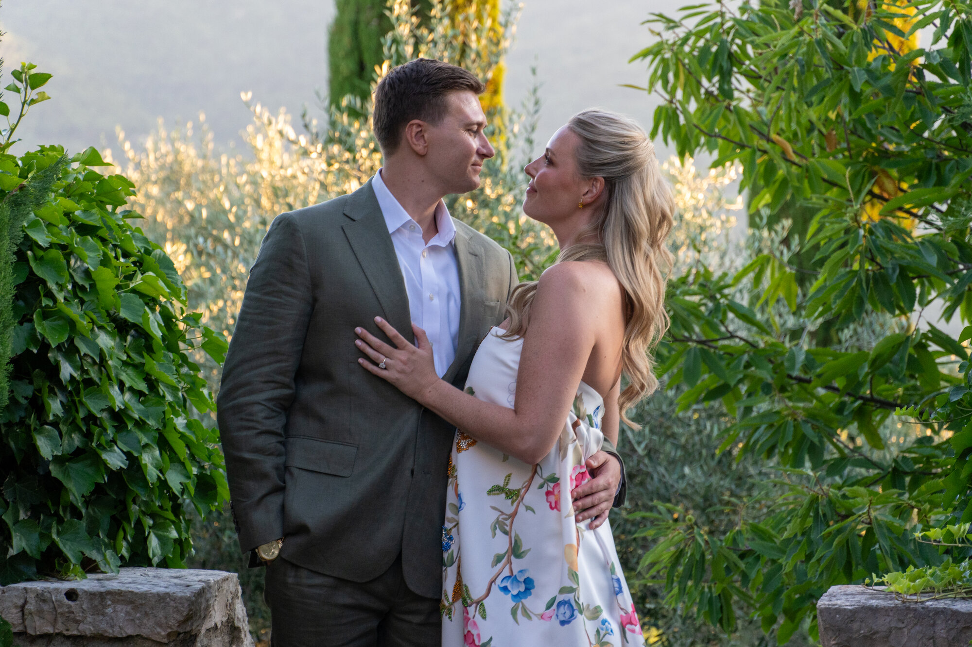 Bride smiling in a floral gown in Tuscany